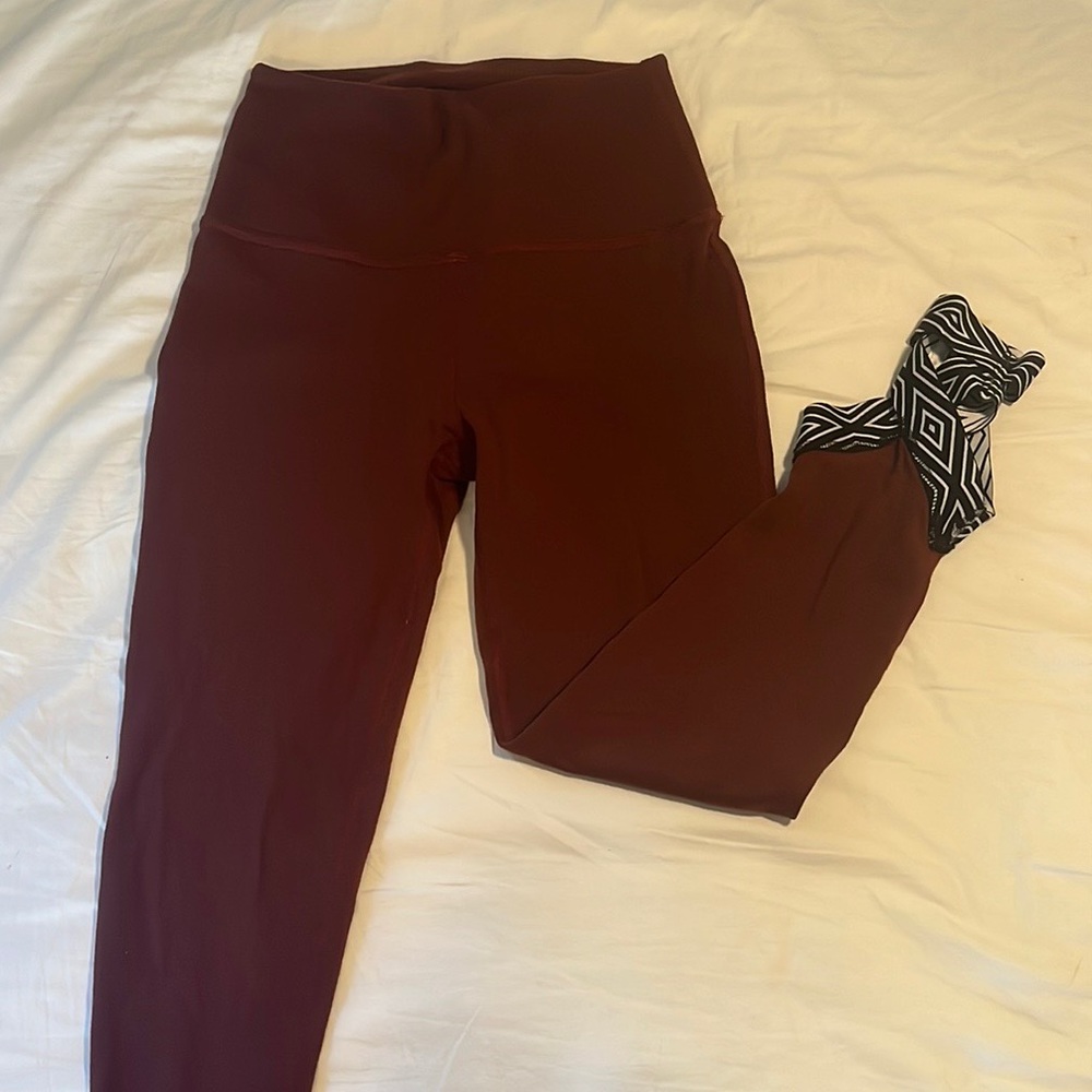 Beyond Yoga rust colored leggings with ankle wrapping cut out detail